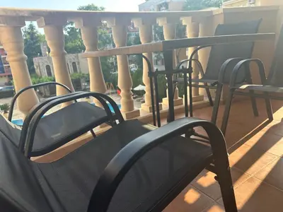 a row of chairs on a balcony with columns at Kalia A7 Sunny Beach in Bŭnzareto