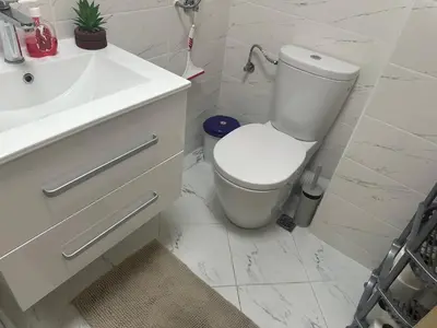 a white bathroom with a toilet and a sink at Kalia A7 Sunny Beach in Bŭnzareto
