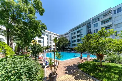 a hotel with a swimming pool in front of a building at Apartment D9 Yassen HV in Sunny Beach