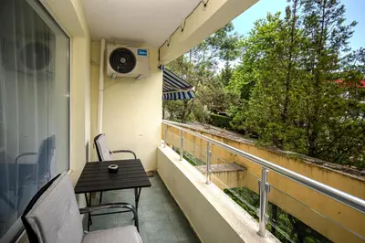 a balcony with a table and chairs and a speaker at Apartment D9 Yassen HV in Sunny Beach