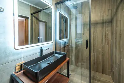 a bathroom with a black sink and a shower at Apartment D9 Yassen HV in Sunny Beach