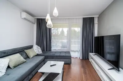 a living room with a couch and a tv at Apartment D9 Yassen HV in Sunny Beach