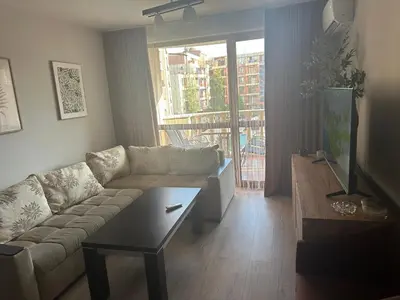 a living room with a couch and a coffee table at Kalia A7 Sunny Beach in Sunny Beach