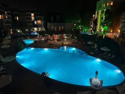 a large swimming pool at night in a city at Kalia A7 Sunny Beach in Sunny Beach