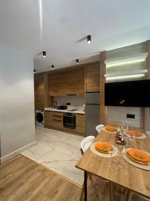 a kitchen with a wooden table with plates on it at VIP Anvers Villa 50 in Elenite