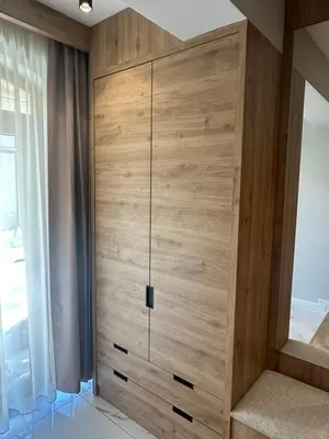 a large wooden cabinet in a room with a window at VIP Anvers Villa 50 in Elenite