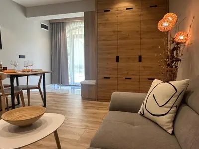 a living room with a couch and a table at VIP Anvers Villa 50 in Elenite