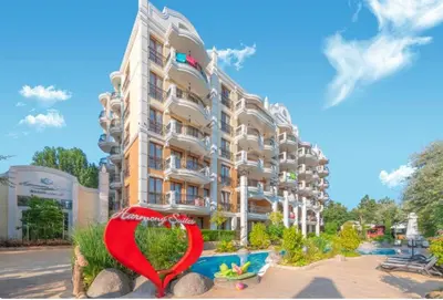 a building with a heart sign in front of it at Harmony Suites Grand Resort 16 in Sunny Beach