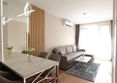 a living room with a table and a couch at Harmony Suites Grand Resort 16 in Sunny Beach