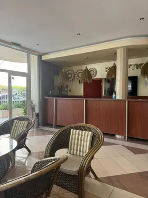 a living room with two chairs and a table at HOLIDAY Suites at Sunny Beach in Sunny Beach