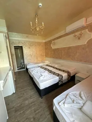 a hotel room with two beds and a chandelier at HOLIDAY Suites at Sunny Beach in Sunny Beach