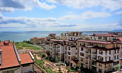 a group of buildings with the ocean in the background at Квартира студія у Panorama Bay 2 in Sveti Vlas