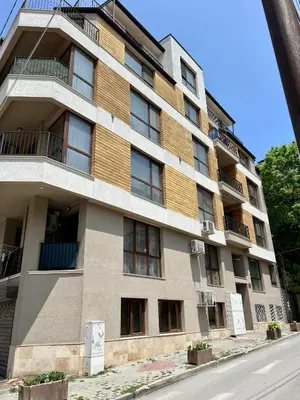 an apartment building on the corner of a street at Urban Nest Varna - Near Center and Bus Station in Varna City