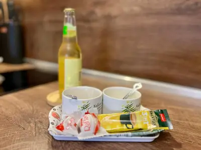 a tray with two cups and a bottle of beer at Urban Nest Varna - Near Center and Bus Station in Varna City