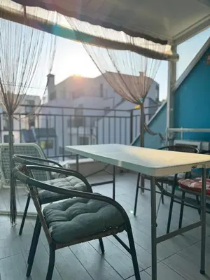 a table and chairs on top of a balcony at Harbour Top-View Terrace 2-BDR Central Apartment in Varna City