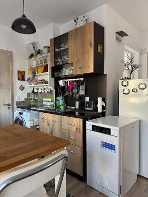 a kitchen with a white refrigerator and a stove at Harbour Top-View Terrace 2-BDR Central Apartment in Varna City
