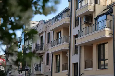 an apartment building with balconies on a city street at Spirit apartment in Burgas City