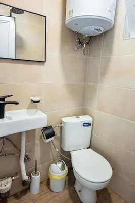 a bathroom with a toilet and a sink at Къмпинг Албатрос in Varna City