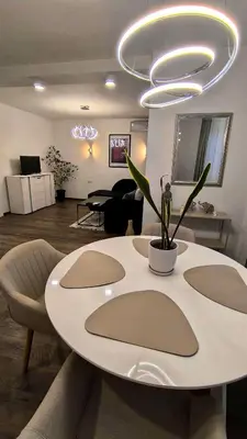 a living room with a white table with a plant on it at Aperto Sozopoli Apartment in Sozopol