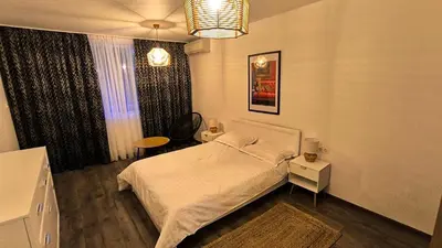 a bedroom with a white bed and a window at Aperto Sozopoli Apartment in Sozopol