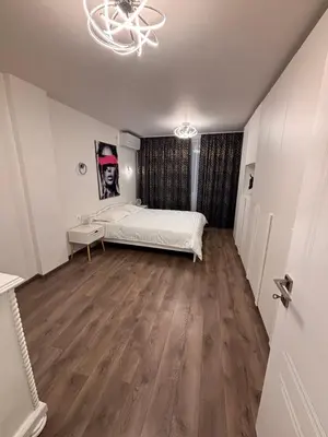 a bedroom with a bed and a wooden floor at Aperto Sozopoli Apartment in Sozopol