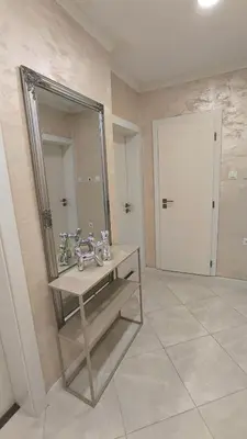 a bathroom with a sink and a large mirror at Aperto Sozopoli Apartment in Sozopol