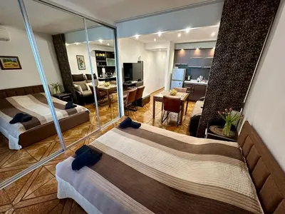 a hotel room with two beds and a living room at Zornitsa View in Burgas City