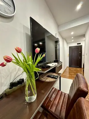 a vase of flowers sitting on a table in a room at Zornitsa View in Burgas City