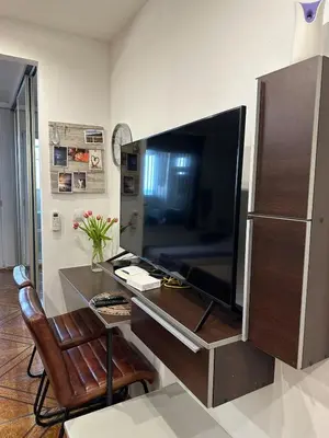 a room with a desk with a large screen television at Zornitsa View in Burgas City