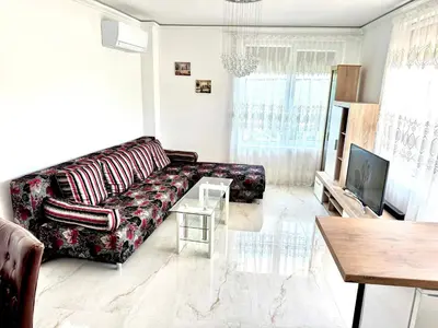 a living room with a couch and a table at Sea apartment in Burgas City