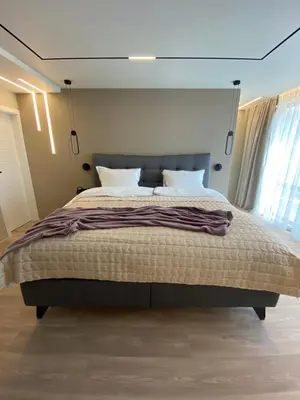 a bedroom with a large bed with white pillows at Luxurious house Sarafovo beach in Burgas City