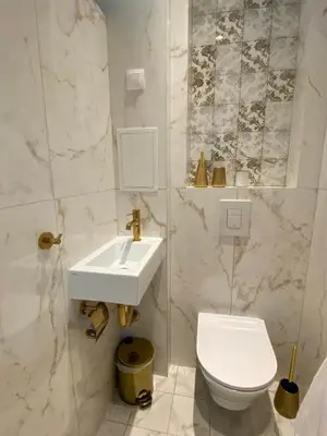 a white bathroom with a sink and a toilet at Luxurious house Sarafovo beach in Burgas City