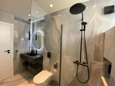 a bathroom with a shower with a toilet and a sink at Luxurious house Sarafovo beach in Burgas City