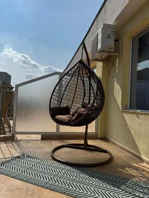 a hammock chair on a balcony on a building at Студиа Осака in Sunny Beach