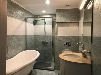 a bathroom with a shower and a tub and a sink at Burgas Center in Burgas City