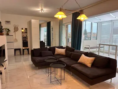 a living room with a brown couch in a living room at Burgas Center in Burgas City