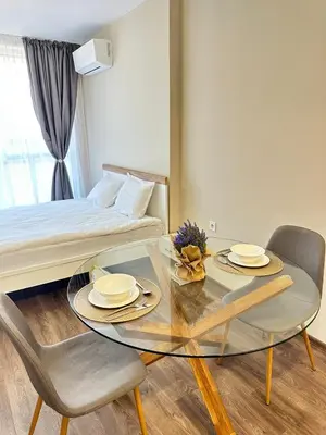 a room with a table and two chairs and a bed at Chantrer in Burgas City
