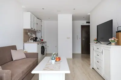 a living room with a couch and a table at Stylish Paradiso Apartment 206 in Nesebar