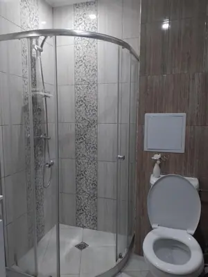a bathroom with a shower with a toilet at Paradiso Aparthotel, Studio 106 in Nesebar