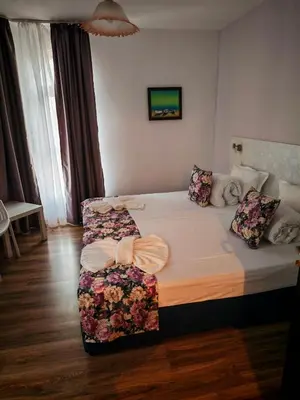 a hotel room with a bed with flowers on it at Chance Sarafovo in Burgas City