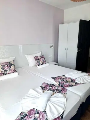 two beds in a room with flowers on them at Chance Sarafovo in Burgas City