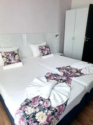a bedroom with two beds with flowers on them at Chance Sarafovo in Burgas City