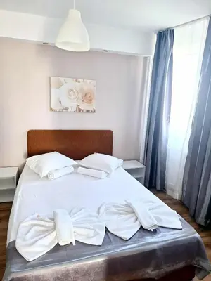a bed with white sheets and towels on it at Chance Sarafovo in Burgas City