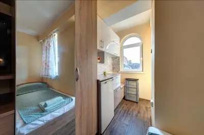 a small room with a bed and a kitchen at Funny-Gunny Room to The Sea Garden in Burgas City