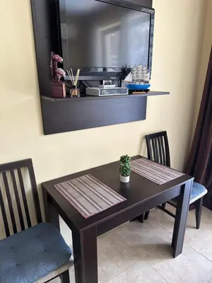 a dining room table and chairs with a mirror on the wall at Студио до плажа Свети Влас in Sveti Vlas