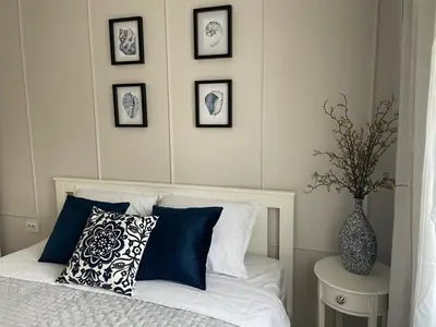 a bedroom with a bed with a vase on a table at Magnoliya residence in Burgas City