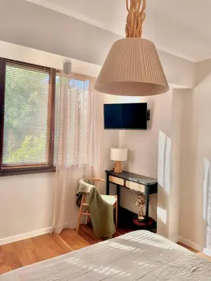 a bedroom with a desk and a bed with a lamp at Magnoliya residence in Burgas City