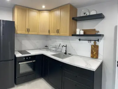 a kitchen with a black refrigerator and a sink at Magnoliya residence in Burgas City