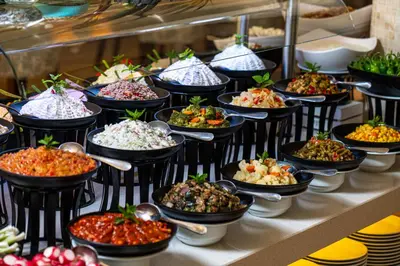 a buffet line with many different types of food at Hotel Miramar Sozopol in Sozopol
