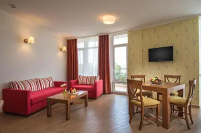 a living room with a couch and a table at Hotel Miramar Sozopol in Sozopol